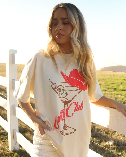 Women's Cowboy Country Club Martini Tee by Charlie Southern, featuring a playful design of a dirty martini with a pink cowboy hat. The ivory tee embodies a fun, country club vibe.