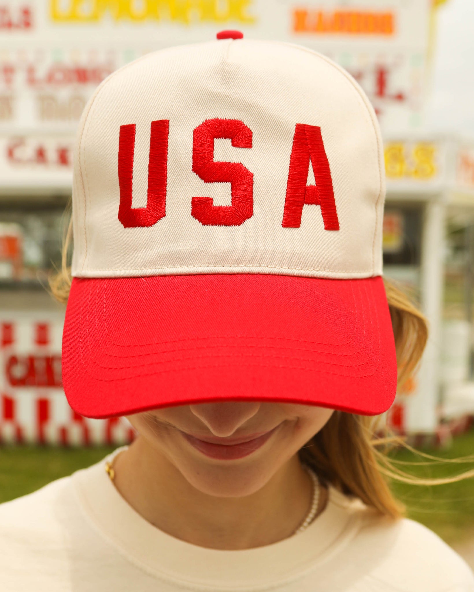 Women's USA Two Tone Trucker Cap by Charlie Southern, featuring an oversized red USA embroidery on an off-white and red cap, perfect for summer and July 4th celebrations.